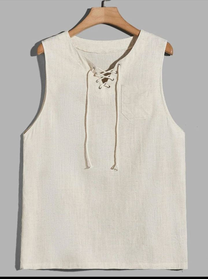 A sleeveless cream-colored linen vest with a lace-up neckline, hanging on a wooden hanger against a gray background.